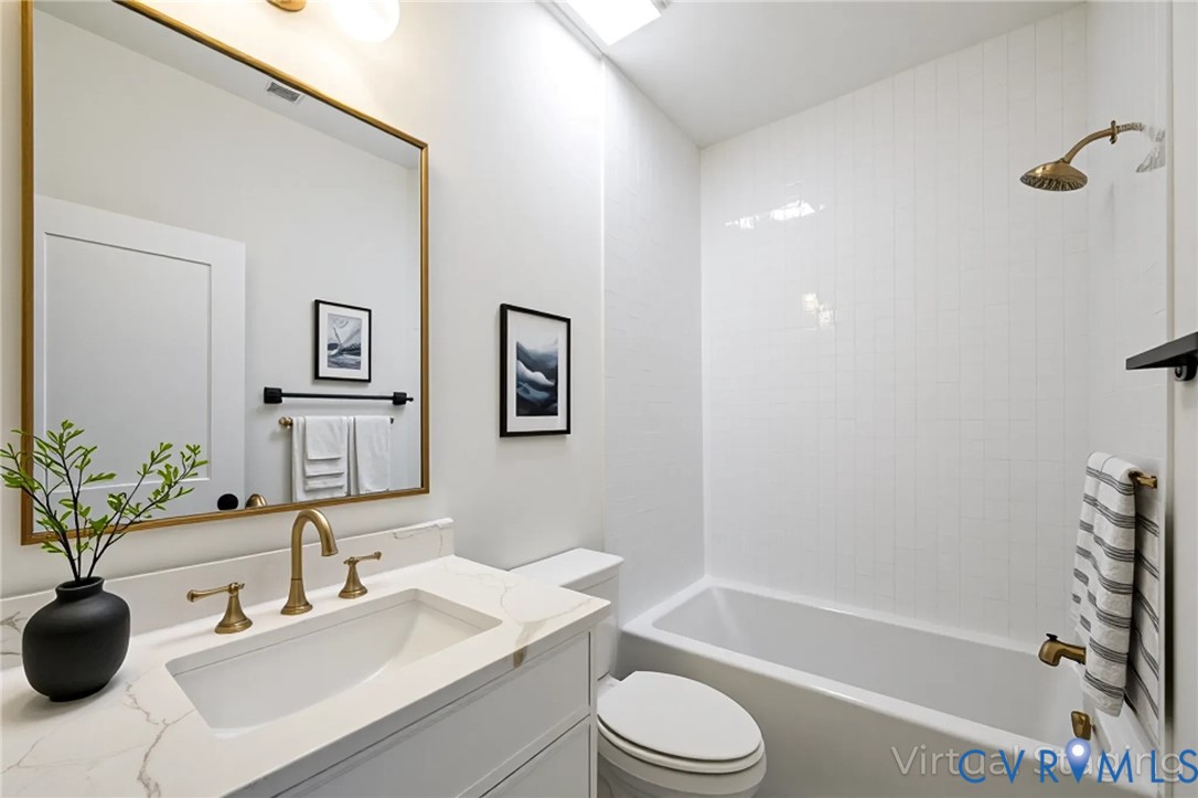3423 Stuart Avenue Richmond, VA 23221 - Photo 28 of 34 a bathroom with a sink a toilet a tub and shower