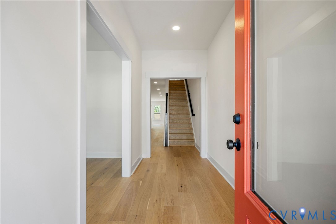 3423 Stuart Avenue Richmond, VA 23221 - Photo 4 of 34 a view of a hallway with wooden floor and staircase