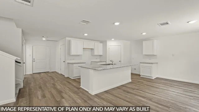 a kitchen with stainless steel appliances granite countertop a white stove top oven and white cabinets