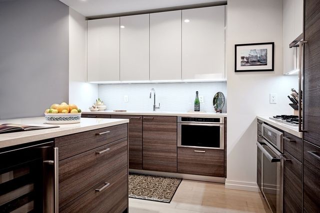 a kitchen with a cabinets and white appliances