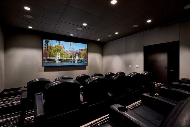 a room with furniture projector and screen