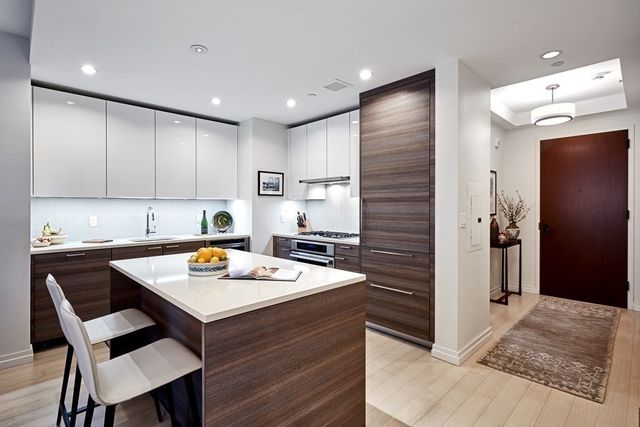 a kitchen with a table chairs and a refrigerator