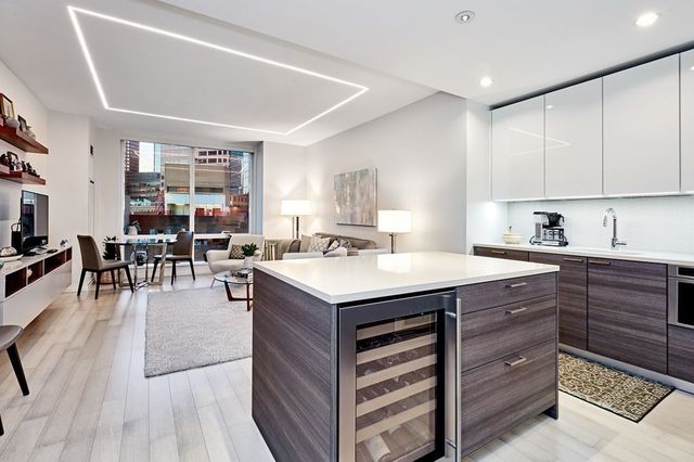 a kitchen with a stove a refrigerator and wooden cabinets