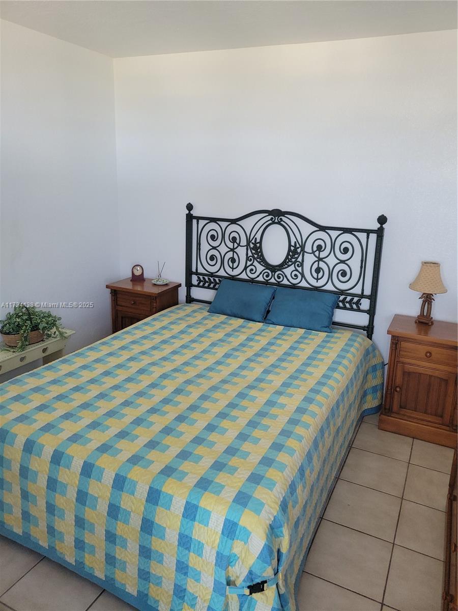 2899 Collins Avenue, Unit 1114 Miami Beach, FL 33140 - Photo 15 of 22 a bedroom with a bed and a table