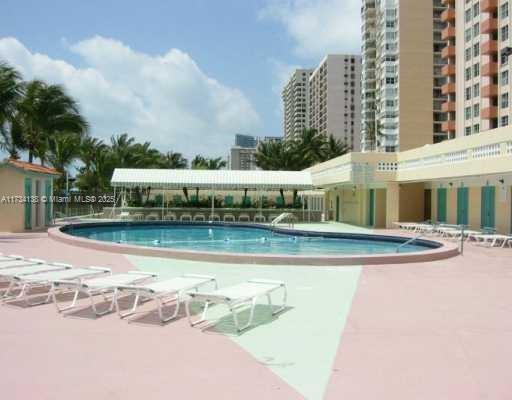 2899 Collins Avenue, Unit 1114 Miami Beach, FL 33140 - Photo 22 of 22 a view of a swimming pool with buildings in the background