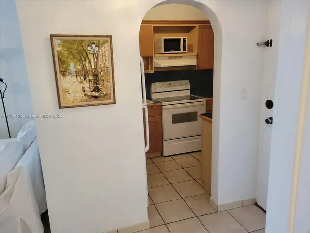 a kitchen with a sink cabinets and appliances