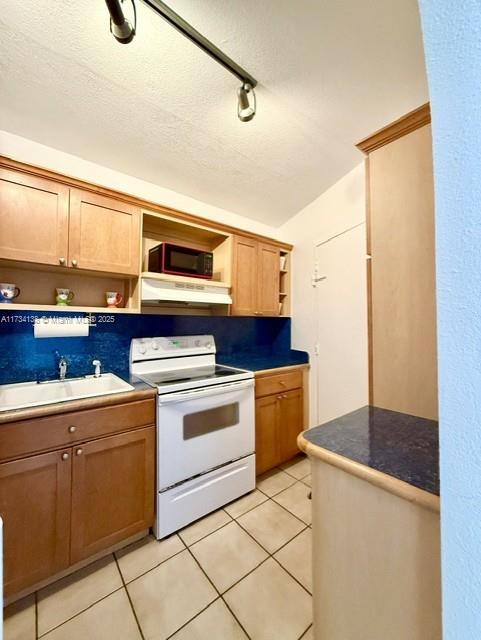2899 Collins Avenue, Unit 1114 Miami Beach, FL 33140 - Photo 9 of 22 a kitchen with a sink cabinets and appliances
