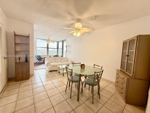 2899 Collins Avenue, Unit 1114 Miami Beach, FL 33140 - Photo 10 of 22 a living room with furniture a refrigerator and a table