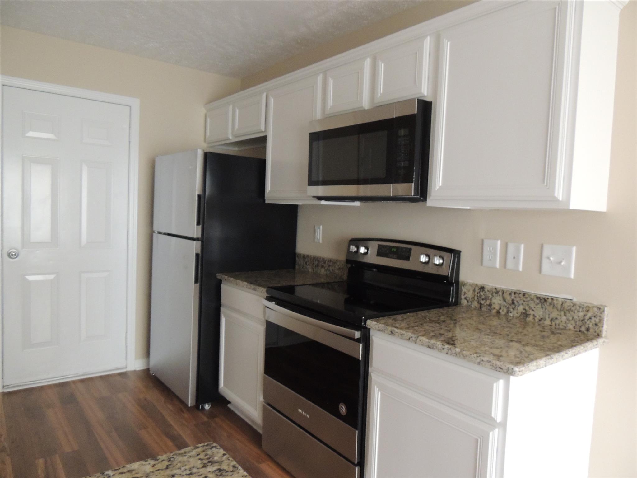 3504 Flora Drive Spring Hill, TN 37174 - Photo 12 of 17 a kitchen with a stove and a microwave