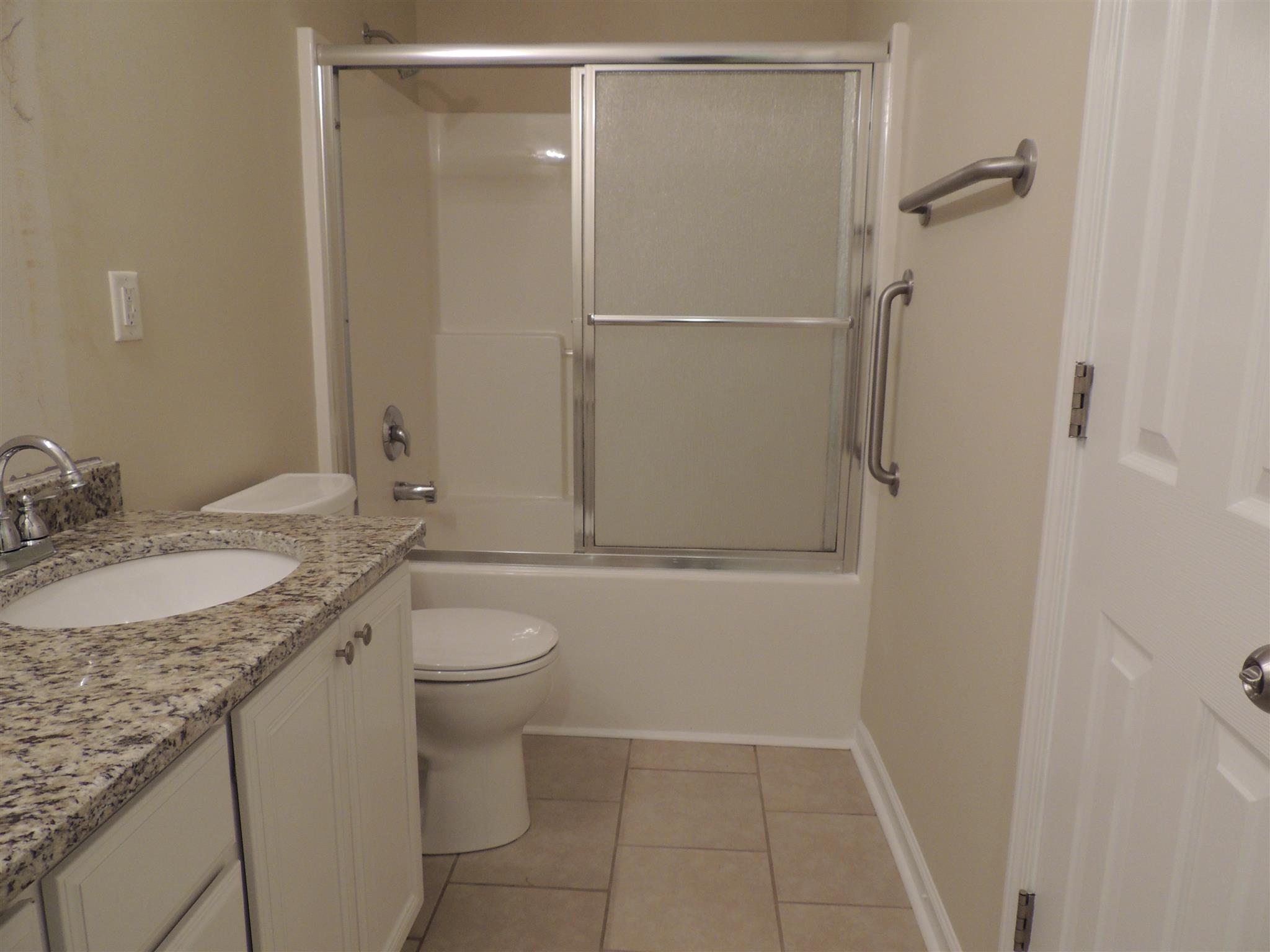 3504 Flora Drive Spring Hill, TN 37174 - Photo 4 of 17 a bathroom with a granite countertop sink toilet and shower