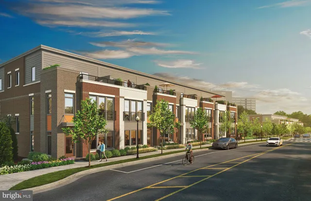 a building exterior with yard and glass door