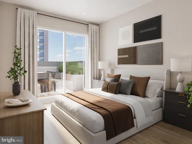 a bedroom with a large bed and a flat tv screen on dresser