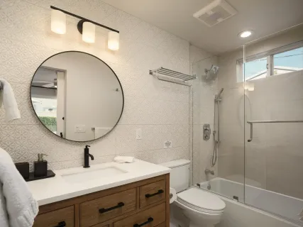 a bathroom with a sink a toilet and a mirror