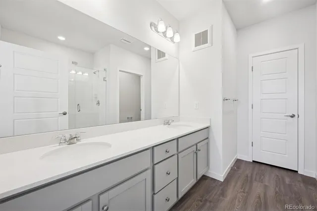 a bathroom with a double vanity sink and a mirror