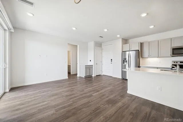 a view of a kitchen with a sink and a refrigerator