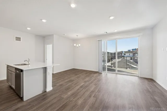 an empty room with wooden floor and fireplace