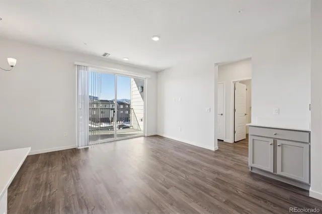a view of a kitchen with wooden floor and a sink