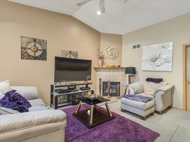a kitchen with a refrigerator a sink dishwasher stove and oven with wooden cabinets