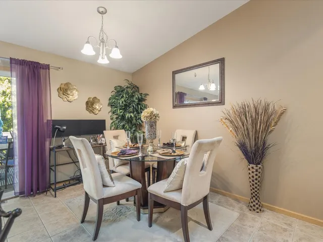 a living room with furniture a chandelier and a dining room