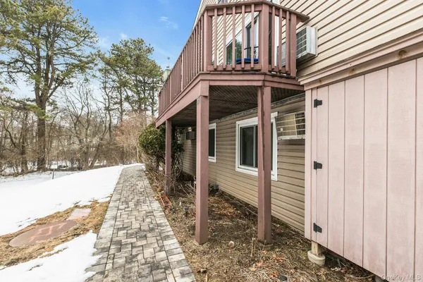 a view of a house with a yard and pathway