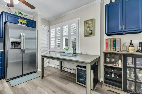 a kitchen with stainless steel appliances granite countertop a refrigerator and wooden cabinets