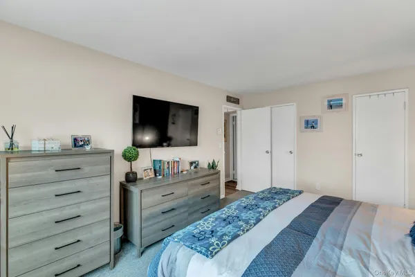 a bedroom with a bed and a flat screen tv in it