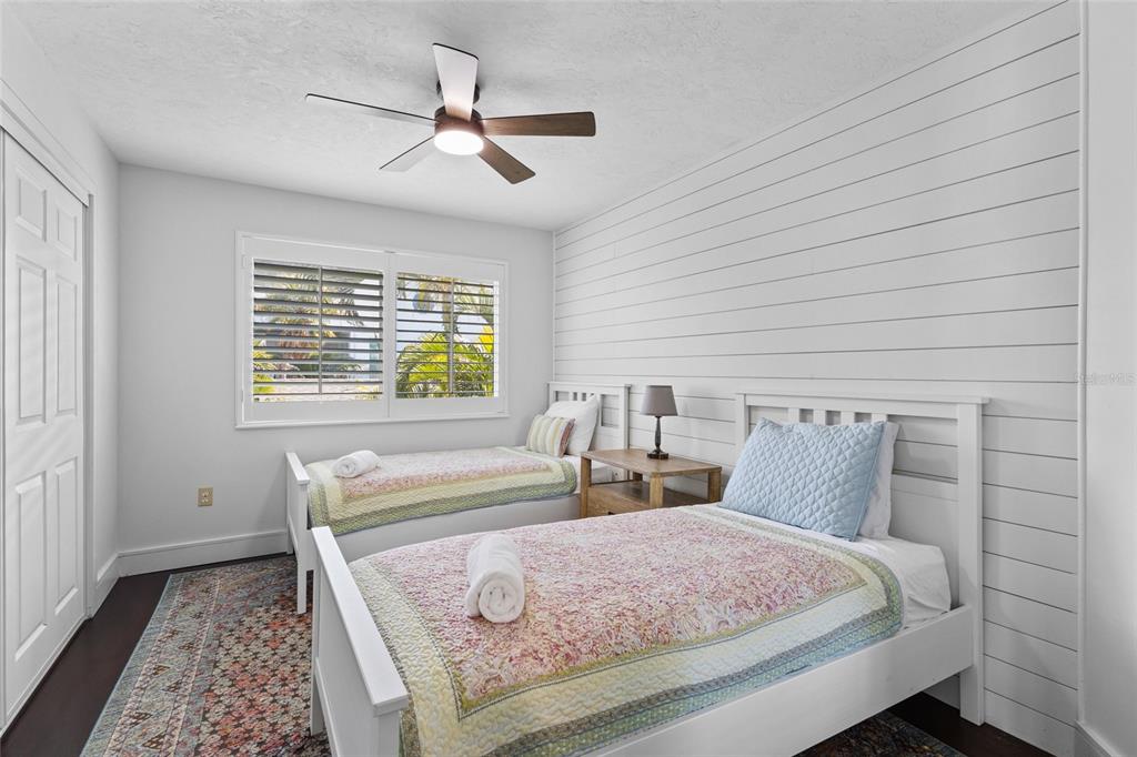 315 Spring Avenue Anna Maria, FL 34216 - Photo 36 of 63 a bedroom with a bed and a chandelier