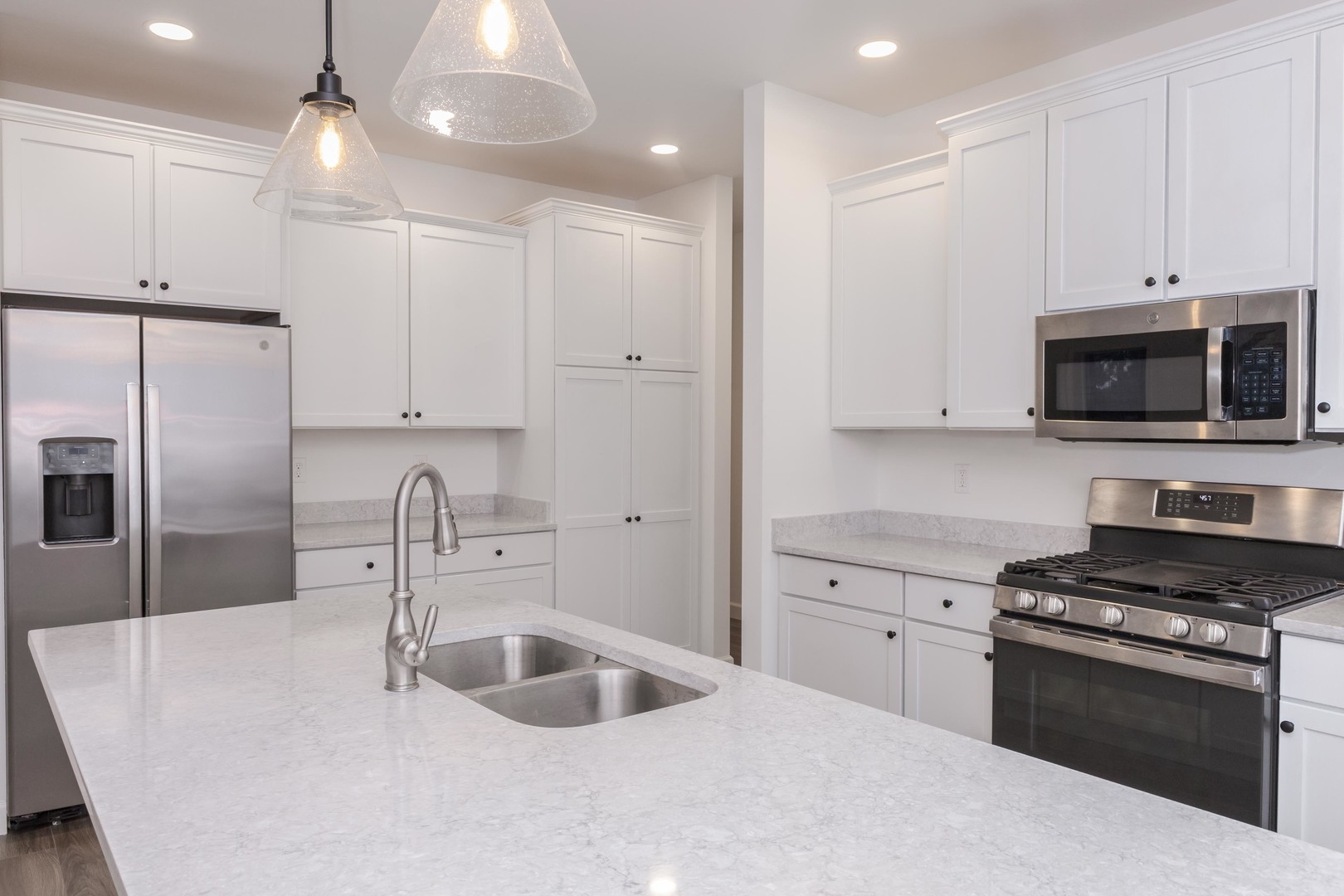 1334 Monterey Pine Drive, Unit 1334 Normal, IL 61761 - Photo 12 of 51 a kitchen with stainless steel appliances a sink a stove a microwave and island