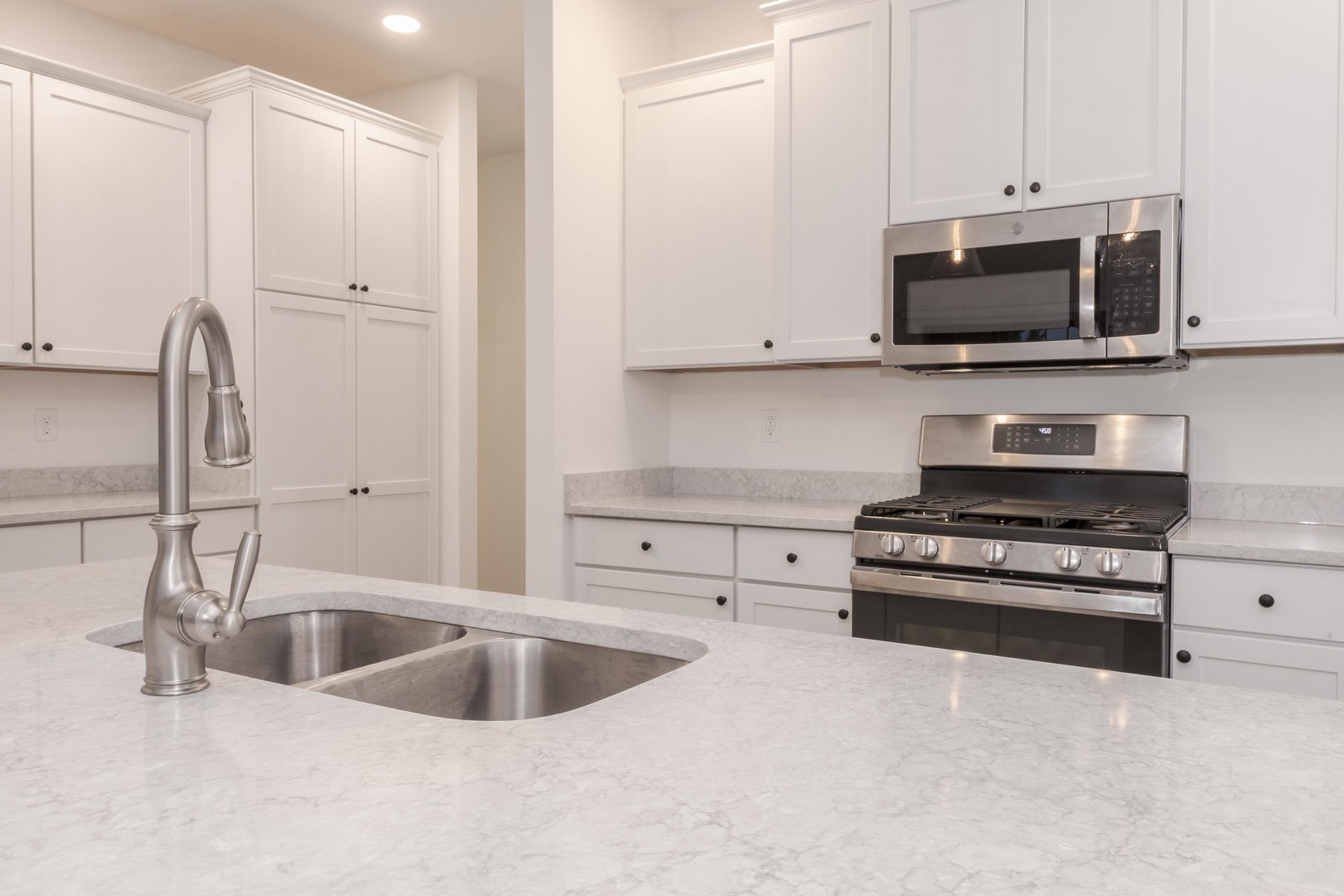 1334 Monterey Pine Drive, Unit 1334 Normal, IL 61761 - Photo 13 of 51 a kitchen with stainless steel appliances a sink a stove and a microwave
