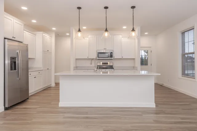 a large kitchen with stainless steel appliances kitchen island a large island in the center