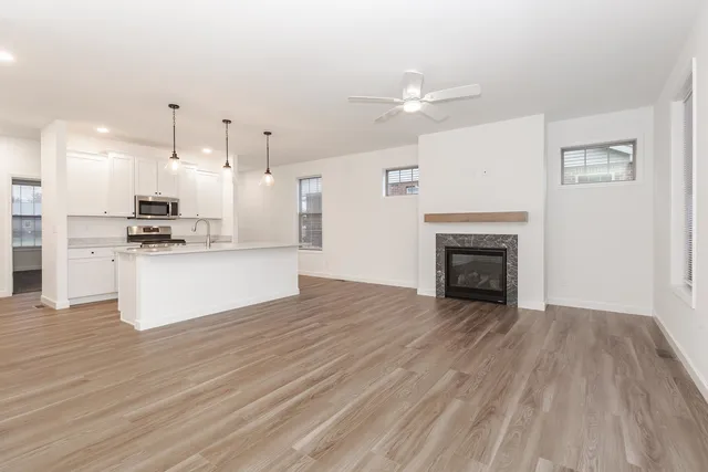 a view of kitchen view with wooden floor and stainless steel appliances