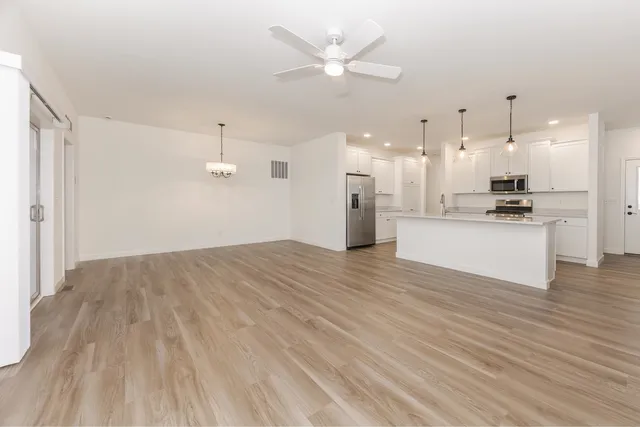 a view of a kitchen with a sink and a refrigerator