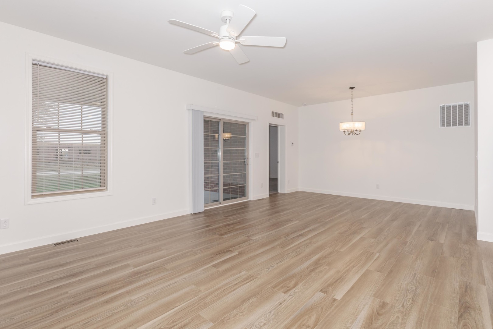1334 Monterey Pine Drive, Unit 1334 Normal, IL 61761 - Photo 22 of 51 a view of an empty room with wooden floor and a window