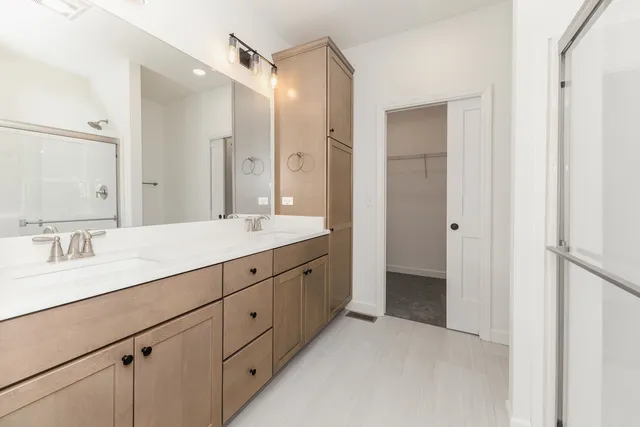 a spacious bathroom with a double vanity sink mirror and double