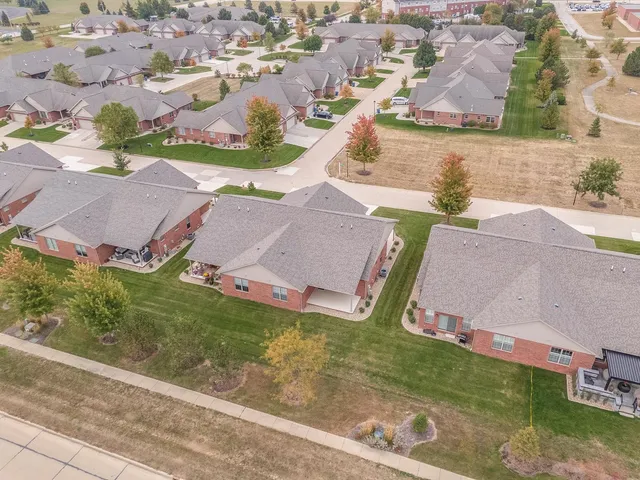 an aerial view of residential houses with outdoor space and street view