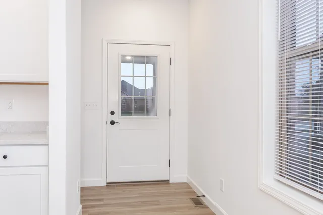 a view of wooden floor and windows in a room