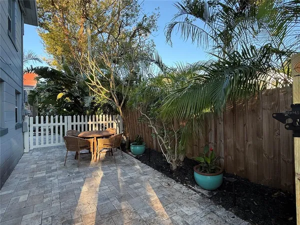 a view of a backyard with a tub and potted plants