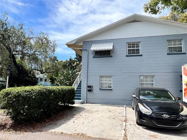 a car parked in front of a white house