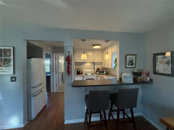 a dining room with kitchen island a table and chairs