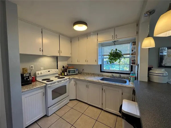 a kitchen with a sink appliances and cabinets
