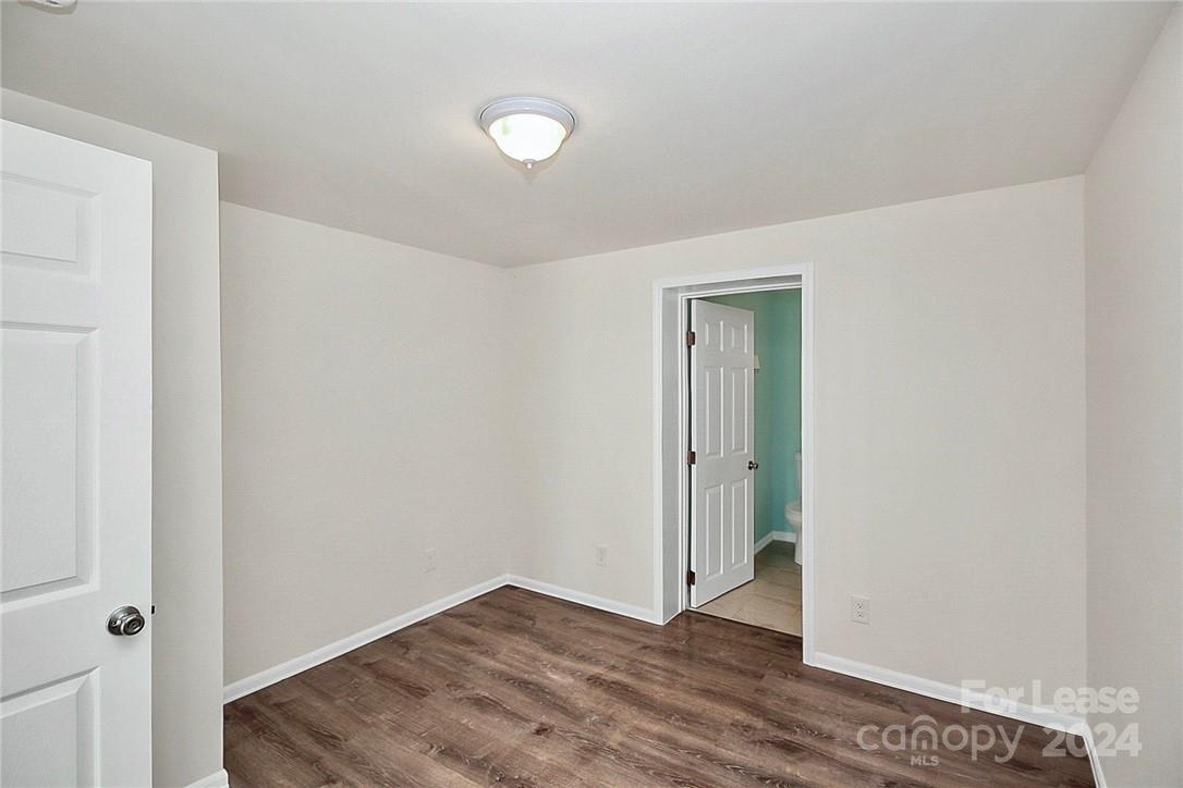 217 Sanders Street, Unit A Fort Mill, SC 29715 - Photo 13 of 16 a view of an empty room with wooden floor