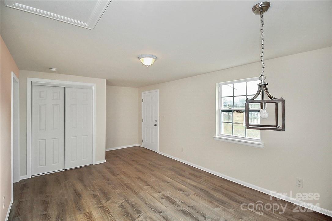 217 Sanders Street, Unit A Fort Mill, SC 29715 - Photo 3 of 16 a view of an empty room with a window and wooden floor