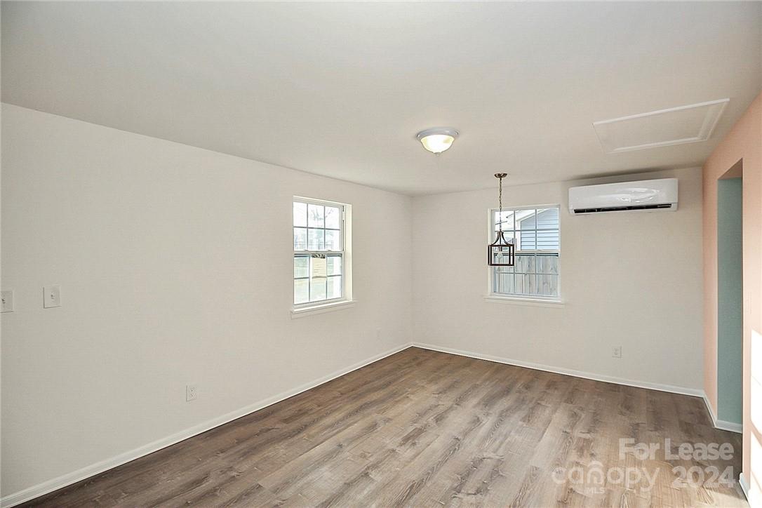 217 Sanders Street, Unit A Fort Mill, SC 29715 - Photo 4 of 16 wooden floor in an empty room with a window