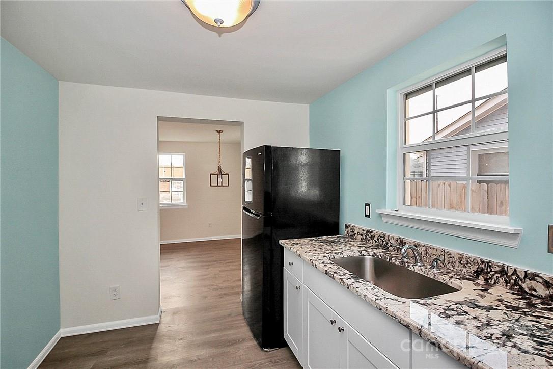 217 Sanders Street, Unit A Fort Mill, SC 29715 - Photo 6 of 16 a kitchen with a refrigerator and a sink