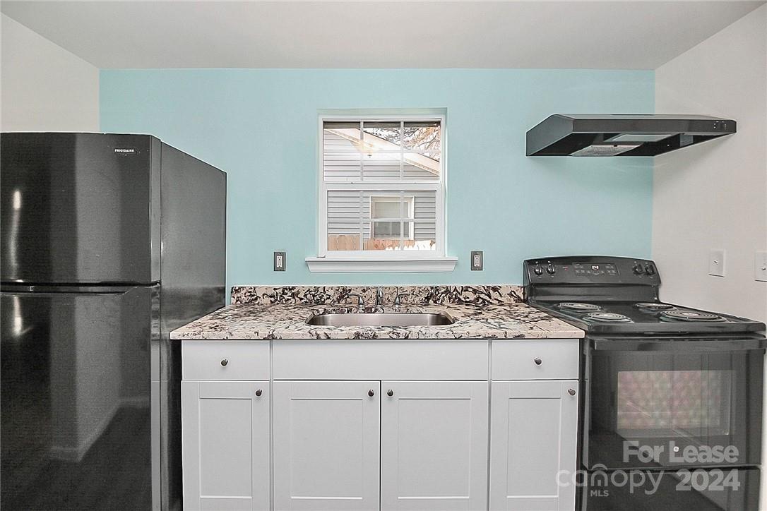 217 Sanders Street, Unit A Fort Mill, SC 29715 - Photo 8 of 16 a kitchen with stainless steel appliances granite countertop a refrigerator and a stove