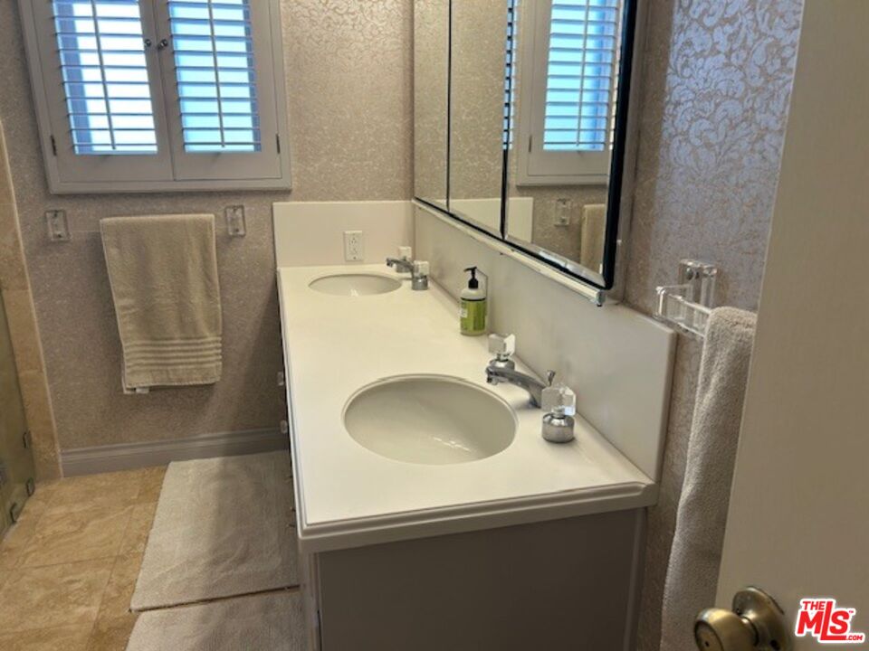 3908 Castlerock Road Malibu, CA 90265 - Photo 15 of 17 a bathroom with a sink and a mirror