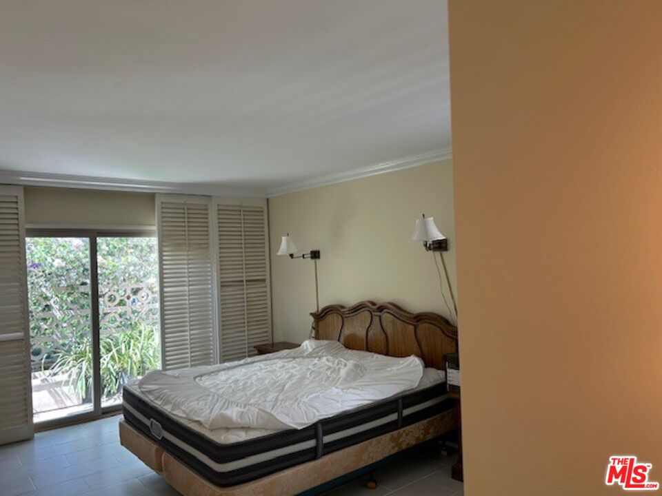 3908 Castlerock Road Malibu, CA 90265 - Photo 16 of 17 a bedroom with a bed and a window