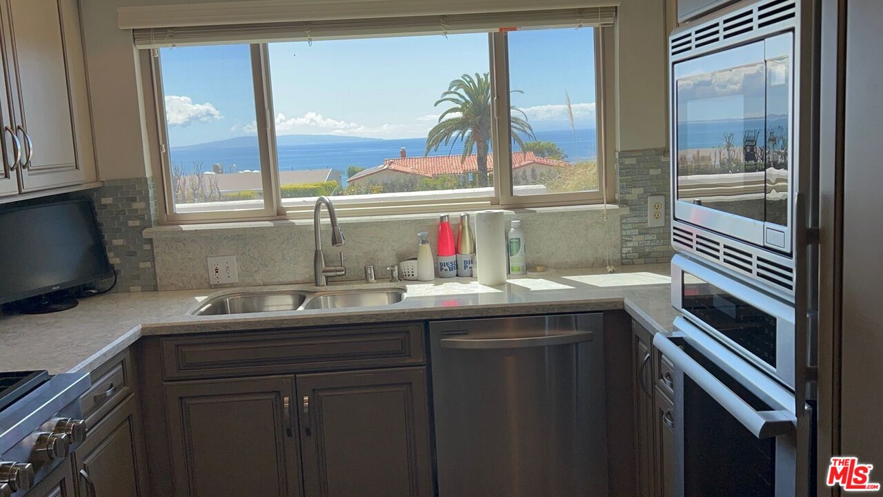 3908 Castlerock Road Malibu, CA 90265 - Photo 3 of 17 a kitchen with a sink and a window
