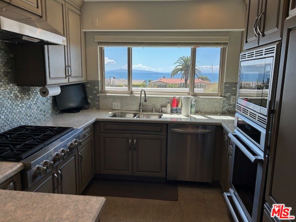 3908 Castlerock Road Malibu, CA 90265 - Photo 4 of 17 a kitchen with a sink stove and microwave