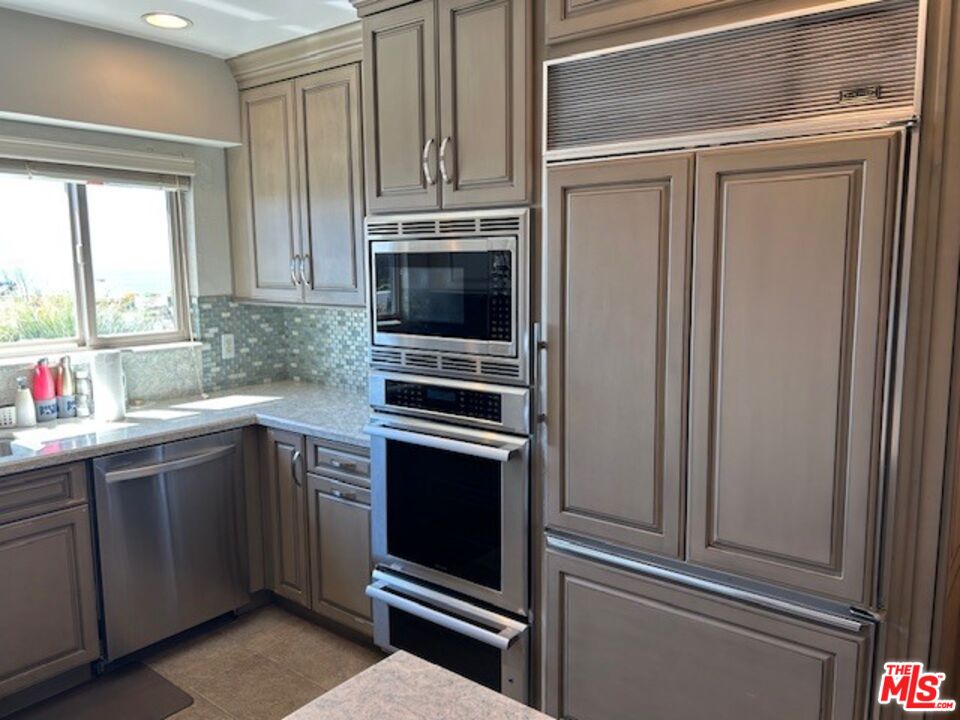 3908 Castlerock Road Malibu, CA 90265 - Photo 5 of 17 a kitchen with appliances cabinets and a window
